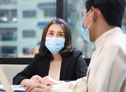 Two employees wearing surgical masks.
